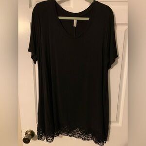 Zenana Signature black short sleeve tunic top with lace look bottom detail.